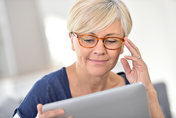 Woman with glasses researching Cataracts