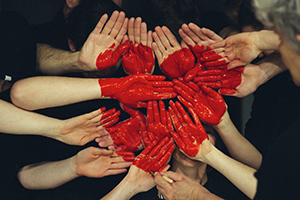 Hands held together painted into a heart