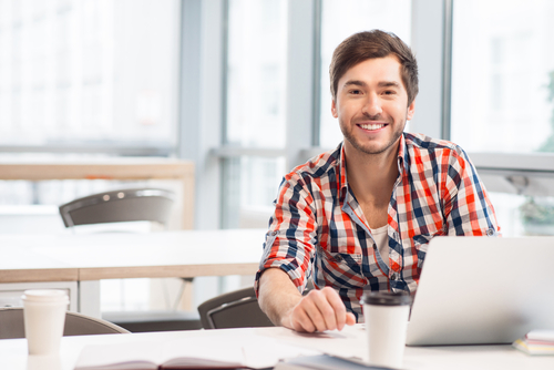 A man sitting at a table smiling 