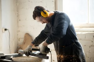 Man using eye protection while wood working