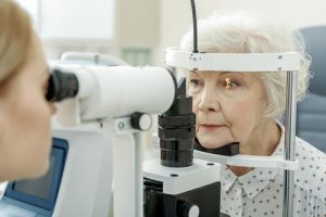 Older woman receiving an eye exam