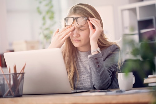 Woman at a computer suffering from eye strain