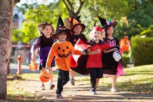 Halloween theme children in costume trick or treating