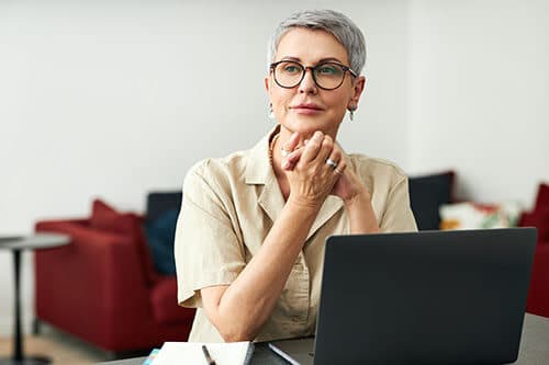 Woman with glasses on her laptop computer